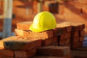 Under,Construction,,Helmet,And,Bricks,For,Building,Site